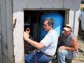 Being a farmer means doing a little bit of everything. Michael Springer (left), helps with this on-farm project.